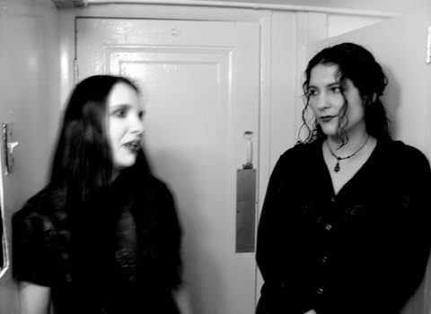 Two girls in black talking